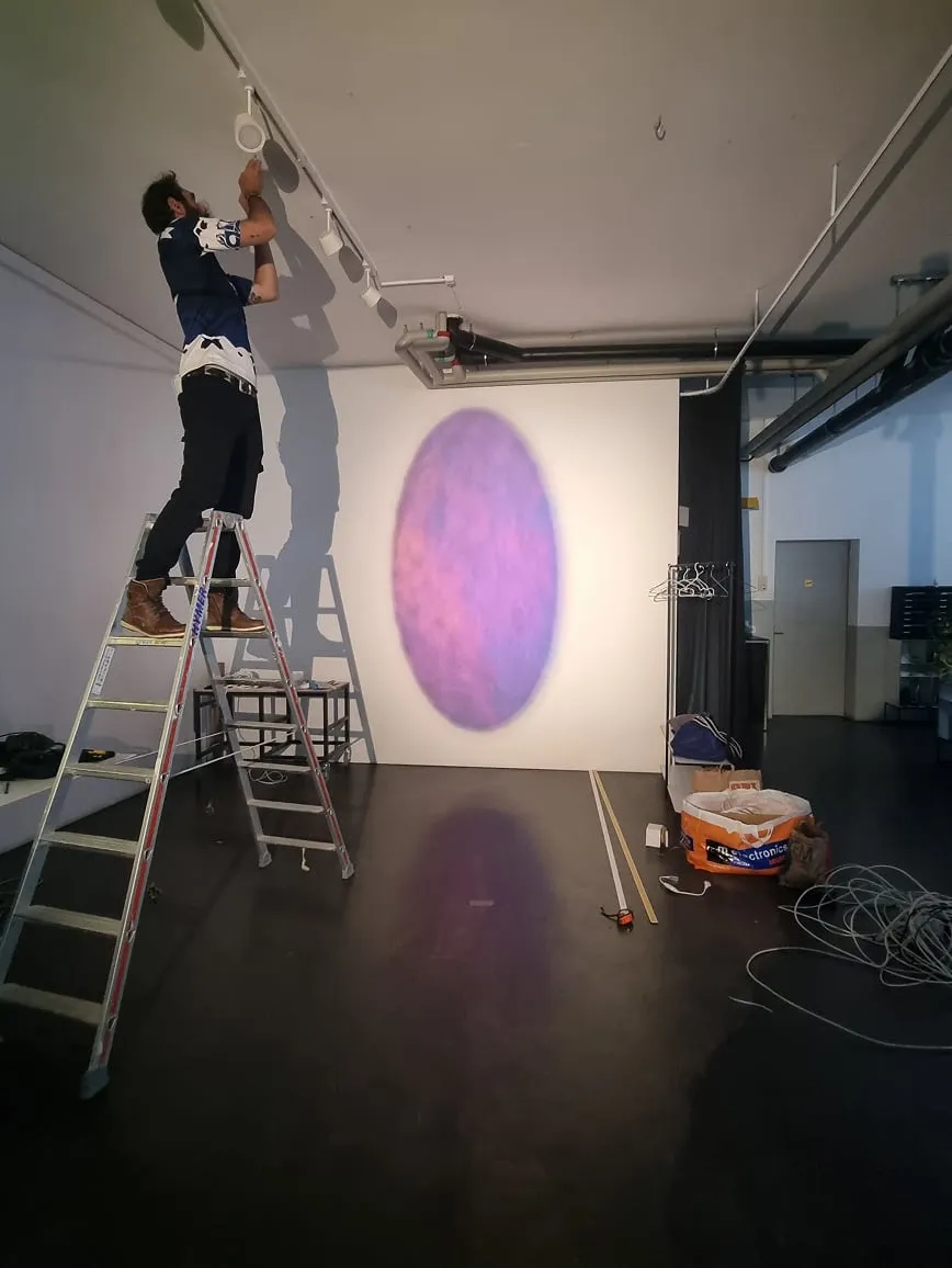 Un homme debout sur une échelle en train de peindre un tableau sur un mur